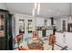 The dining area is part of an open concept with modern lighting, glass doors, and easy access to the kitchen at 4294 Wooley Ave, North Port, FL 34287