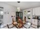 The open concept dining area features a glass table and chairs adjacent to the kitchen and backyard access at 4294 Wooley Ave, North Port, FL 34287
