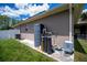 Home exterior featuring water filtration system with well-maintained lawn and garden space at 4294 Wooley Ave, North Port, FL 34287
