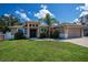 Charming single Gathering home featuring a well-manicured lawn and a two-car garage at 4294 Wooley Ave, North Port, FL 34287