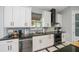 Well-equipped kitchen with white cabinets, stainless appliances, and stylish tile backsplash at 4294 Wooley Ave, North Port, FL 34287