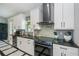This kitchen features stainless steel appliances, granite countertops, white cabinetry, and subway tile backsplash at 4294 Wooley Ave, North Port, FL 34287