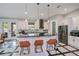 Bright kitchen with stainless steel appliances, granite countertops, and convenient breakfast bar seating at 4294 Wooley Ave, North Port, FL 34287