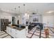 Open kitchen with island, granite countertops, stainless appliances overlooking the living room at 4294 Wooley Ave, North Port, FL 34287
