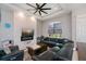 Inviting living room featuring a contemporary fireplace, large window, and comfortable sectional at 4294 Wooley Ave, North Port, FL 34287