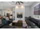 Cozy living room with statement fireplace, ceiling fan, and comfortable seating and modern decor at 4294 Wooley Ave, North Port, FL 34287