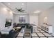 Sophisticated living room with modern fireplace and large sectional sofa and contemporary fan at 4294 Wooley Ave, North Port, FL 34287