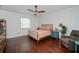 The main bedroom is well-lit with hardwood floors, a ceiling fan, and views of the backyard at 4294 Wooley Ave, North Port, FL 34287