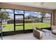 Relaxing screened patio with tiled floors and views of the backyard at 4294 Wooley Ave, North Port, FL 34287