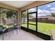 Screened patio perfect for entertaining with view of the backyard, playground, and seating area at 4294 Wooley Ave, North Port, FL 34287