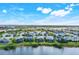 An aerial view shows a beautiful community with waterfront homes and mature landscaping at 43249 Treadway Dr, Punta Gorda, FL 33982