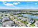 Scenic aerial view of homes in a well-planned community, lush landscaping, and a tranquil lake at 43249 Treadway Dr, Punta Gorda, FL 33982
