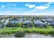 This aerial view showcases homes with pools and manicured landscaping near a scenic lake at 43249 Treadway Dr, Punta Gorda, FL 33982