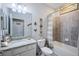 Well-lit bathroom features a granite countertop vanity, toilet, and a shower/tub combination with tiled walls at 43249 Treadway Dr, Punta Gorda, FL 33982