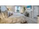 Bedroom with a comfortable queen bed and stylish decor with a view to a bright window at 43249 Treadway Dr, Punta Gorda, FL 33982