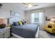 This cozy bedroom boasts a large bed with stylish decor, plus a ceiling fan and bright window at 43249 Treadway Dr, Punta Gorda, FL 33982