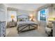 Comfortable bedroom featuring a queen bed, matching nightstands and decorative window treatments at 43249 Treadway Dr, Punta Gorda, FL 33982