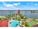 Enjoy the community pool, lounge area, and lakeside views, creating a perfect setting for relaxation and recreation at 43249 Treadway Dr, Punta Gorda, FL 33982