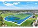 Spectacular community football field and running track, surrounded by lush greenery and inviting lake views at 43249 Treadway Dr, Punta Gorda, FL 33982