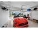 Spacious garage with a red sports car and well-organized shelving for all your storage needs at 43249 Treadway Dr, Punta Gorda, FL 33982