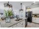 Kitchen island showcasing a stainless steel sink with view to the breakfast nook and stainless steel refrigerator at 43249 Treadway Dr, Punta Gorda, FL 33982