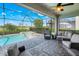 Screened lanai featuring a pool, spa, and comfortable outdoor seating, perfect for relaxation and entertaining at 43249 Treadway Dr, Punta Gorda, FL 33982