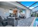 This comfortable covered patio includes an outdoor television and plenty of seating at 43249 Treadway Dr, Punta Gorda, FL 33982