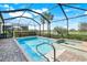 A stunning in-ground pool and spa are surrounded by a screened enclosure and lush landscaping at 43249 Treadway Dr, Punta Gorda, FL 33982