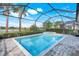 Screened-in pool and spa with a view of the lake at 43249 Treadway Dr, Punta Gorda, FL 33982