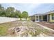 Expansive backyard featuring a screened-in lanai, fenced in yard perfect for outdoor enjoyment and privacy at 4413 S San Mateo Dr, North Port, FL 34288