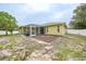 A view of the backyard showcasing a screened-in lanai with ample space for outdoor gatherings at 4413 S San Mateo Dr, North Port, FL 34288