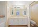 Bright bathroom featuring a double vanity, lots of storage, and a separate toilet room at 4413 S San Mateo Dr, North Port, FL 34288