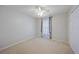 A bedroom featuring neutral paint, carpet, a ceiling fan, a closet, and a window at 4413 S San Mateo Dr, North Port, FL 34288