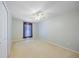 A neutral bedroom with carpet, a ceiling fan, and a window with curtains at 4413 S San Mateo Dr, North Port, FL 34288