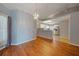 Dining area with wood floors, modern chandelier, and views of the kitchen at 4413 S San Mateo Dr, North Port, FL 34288