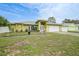 Charming single-story home with a well-manicured lawn and a two-car garage under a bright blue sky at 4413 S San Mateo Dr, North Port, FL 34288