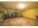 Spacious garage with neutral colored walls, rolling door and concrete floors for convenient parking and storage at 4413 S San Mateo Dr, North Port, FL 34288