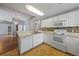 Bright kitchen with white cabinets, stainless steel dishwasher, and breakfast bar at 4413 S San Mateo Dr, North Port, FL 34288