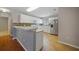 Bright kitchen with white cabinets, stainless steel fridge, breakfast bar, and tile backsplash at 4413 S San Mateo Dr, North Port, FL 34288