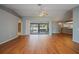 Open-concept living room with wood flooring, sliding glass doors, and an airy ambiance at 4413 S San Mateo Dr, North Port, FL 34288