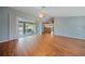 Bright living space with wood floors, sliding glass doors to the lanai, and ceiling fan at 4413 S San Mateo Dr, North Port, FL 34288
