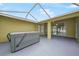 Covered outdoor patio featuring a hot tub and sliding glass doors leading to the interior at 4413 S San Mateo Dr, North Port, FL 34288
