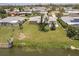 Aerial view showcasing a spacious yard, waterfront access, and a tranquil neighborhood at 444 Edgewood Rd, Venice, FL 34293