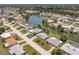 A residential area is shown with waterfront homes along a lake and canal with lush tree cover at 444 Edgewood Rd, Venice, FL 34293