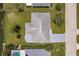 A high-angle aerial view of a home shows its roof and property with adjacent homes nearby at 444 Edgewood Rd, Venice, FL 34293