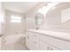 Bright bathroom with white cabinets, a modern faucet, and a large vanity mirror at 444 Edgewood Rd, Venice, FL 34293