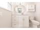 Updated bathroom with new white vanity, modern faucet, mirror, and cabinet with open shelf at 444 Edgewood Rd, Venice, FL 34293