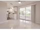 Dining room with view of screened lanai and bright kitchen at 444 Edgewood Rd, Venice, FL 34293