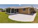 The backyard features a screened lanai and a concrete patio, offering ample space for outdoor entertaining and relaxation at 444 Edgewood Rd, Venice, FL 34293