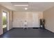 The spacious garage features an epoxy floor and utility sink with easy access to outdoors through a glass panel door at 444 Edgewood Rd, Venice, FL 34293
